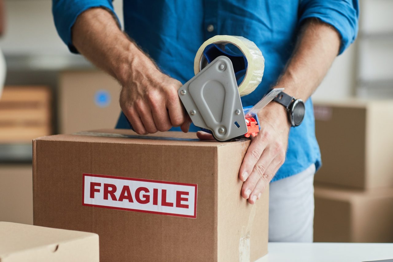 man packing box close up